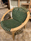 Stylish moon chair with wooden frame and green leather seat