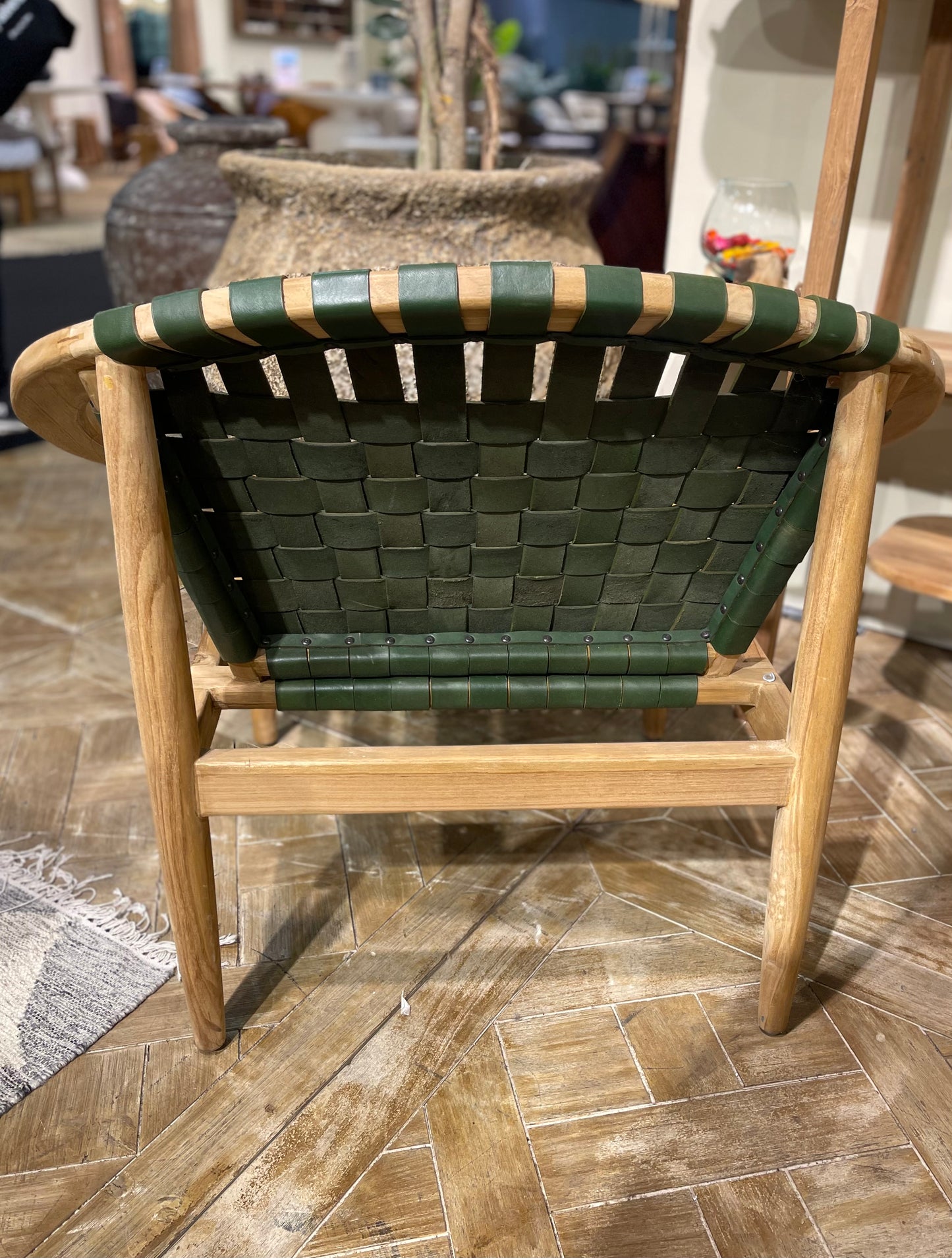 Stylish moon chair with wooden frame and green leather seat