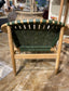 Stylish moon chair with wooden frame and green leather seat