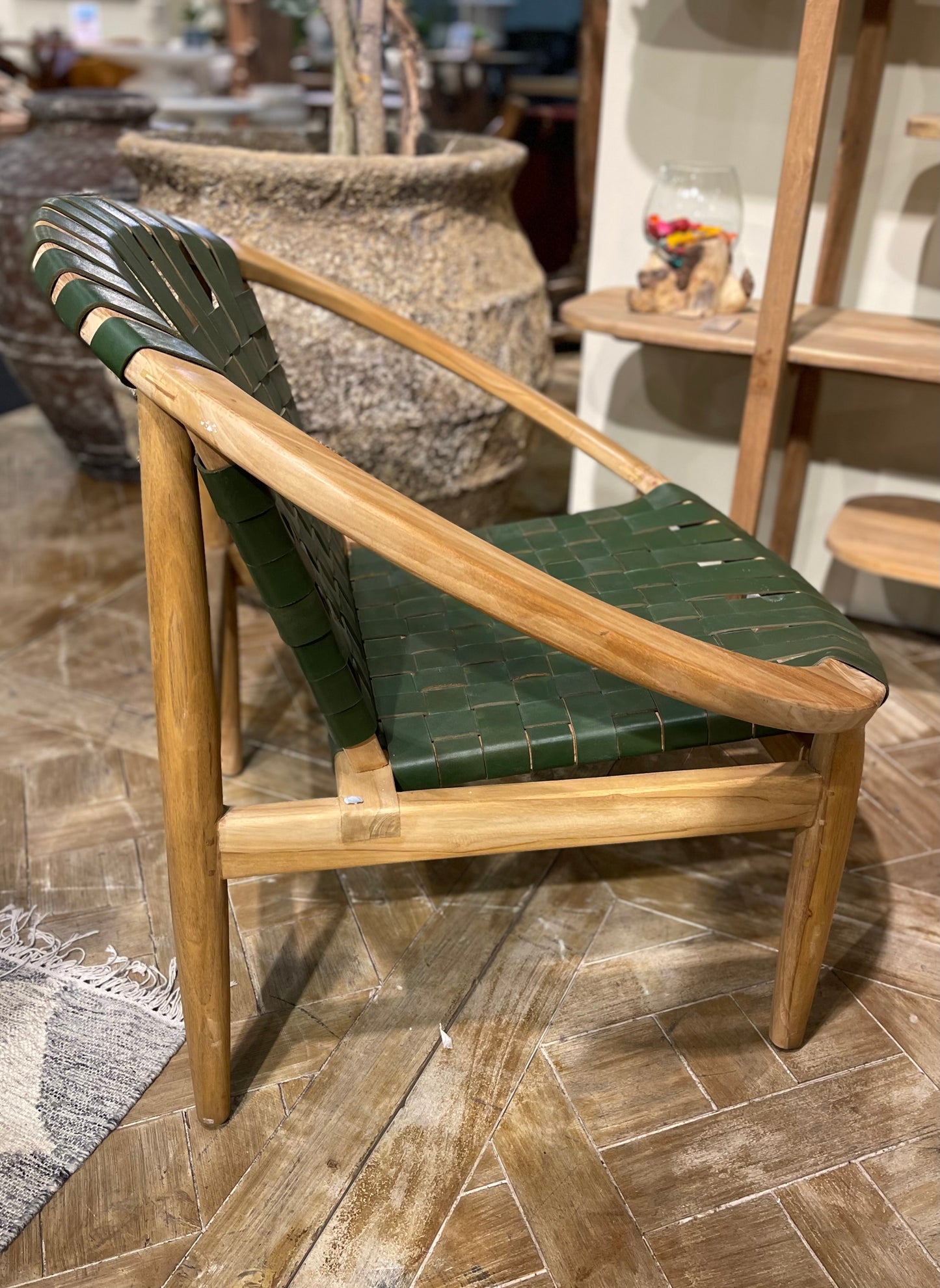 Stylish moon chair with wooden frame and green leather seat