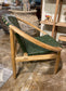 Stylish moon chair with wooden frame and green leather seat