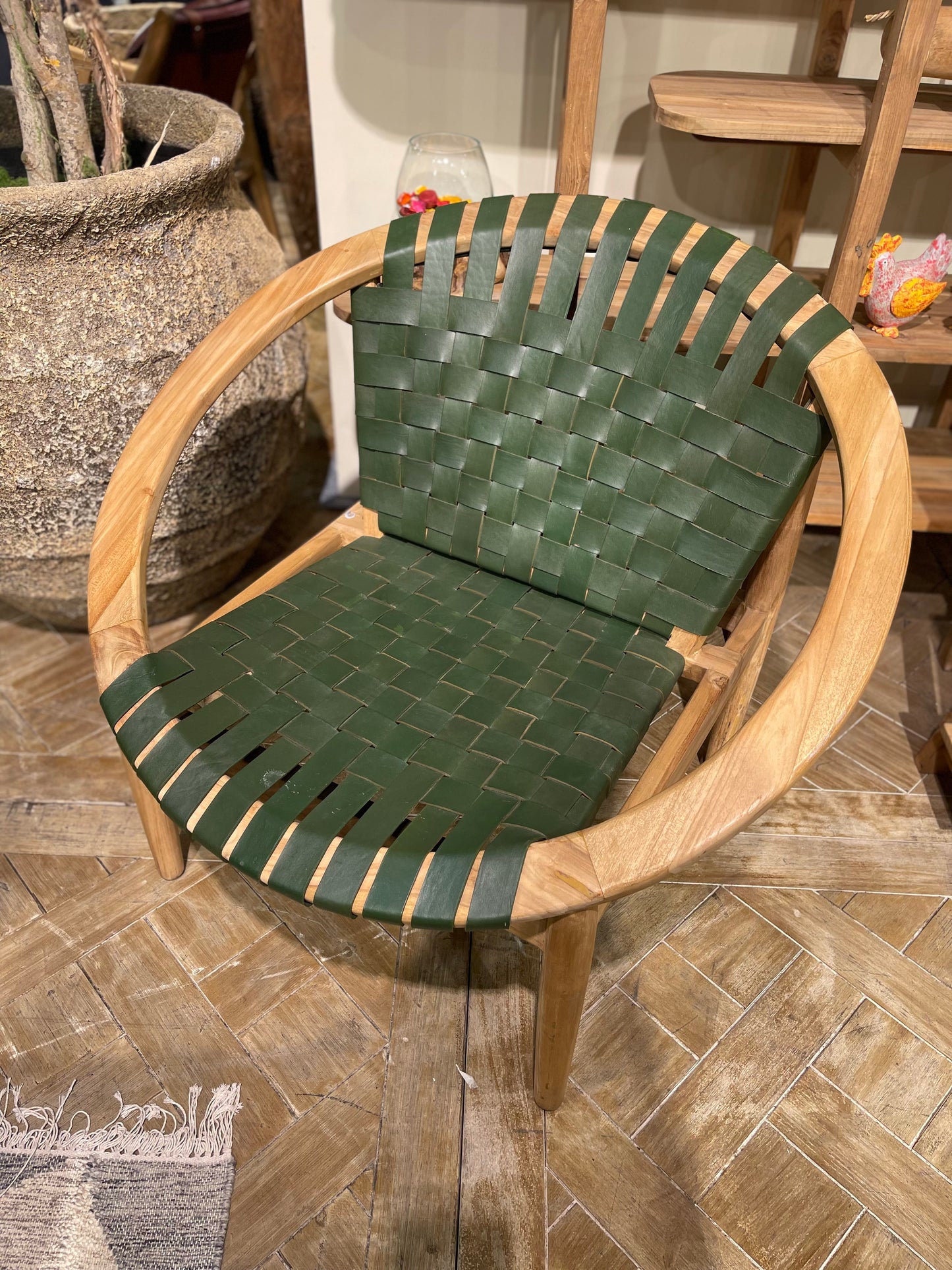 Stylish moon chair with wooden frame and green leather seat