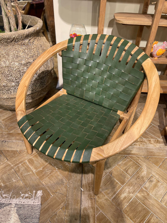 Stylish moon chair with wooden frame and green leather seat