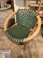 Stylish moon chair with wooden frame and green leather seat