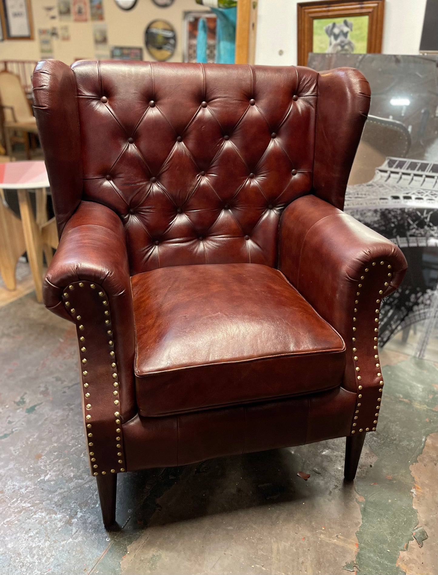 Chestnut brown leather armchair with button back