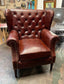 Chestnut brown leather armchair with button back