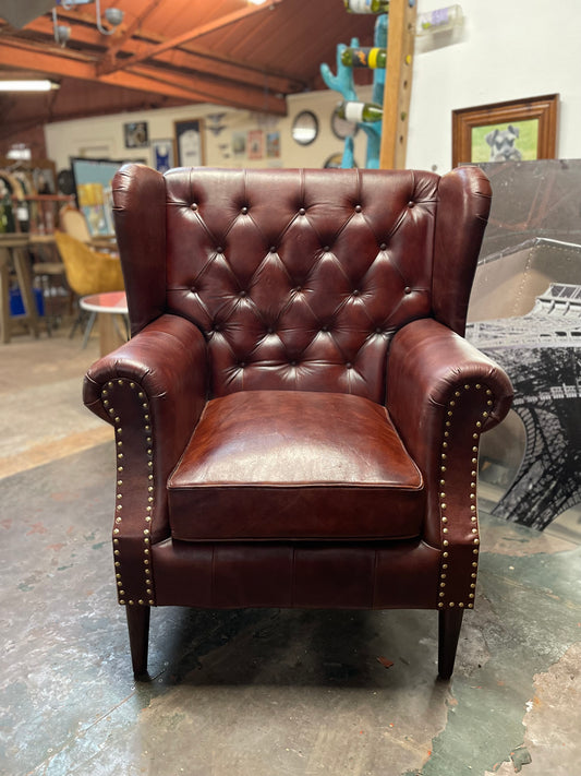 Chestnut brown leather armchair with button back