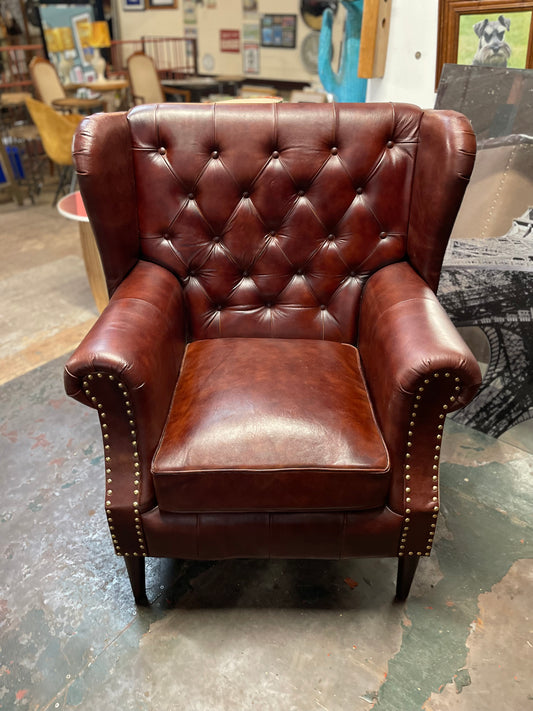 Chestnut brown leather armchair with button back