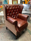 Chestnut brown leather armchair with button back