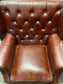 Chestnut brown leather armchair with button back
