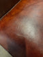 Chestnut brown leather armchair with button back