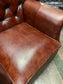 Chestnut brown leather armchair with button back