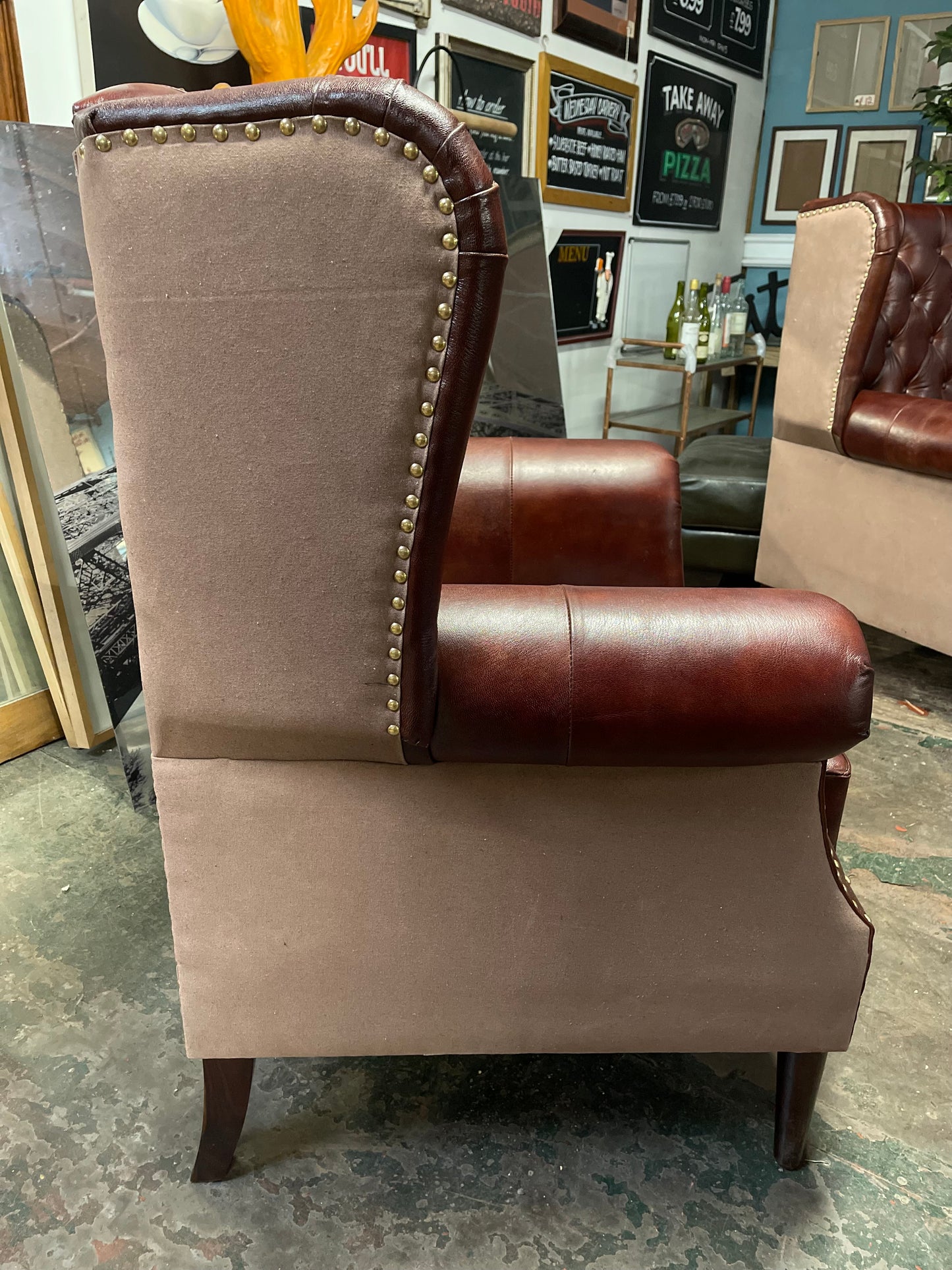 Chestnut brown leather armchair with button back