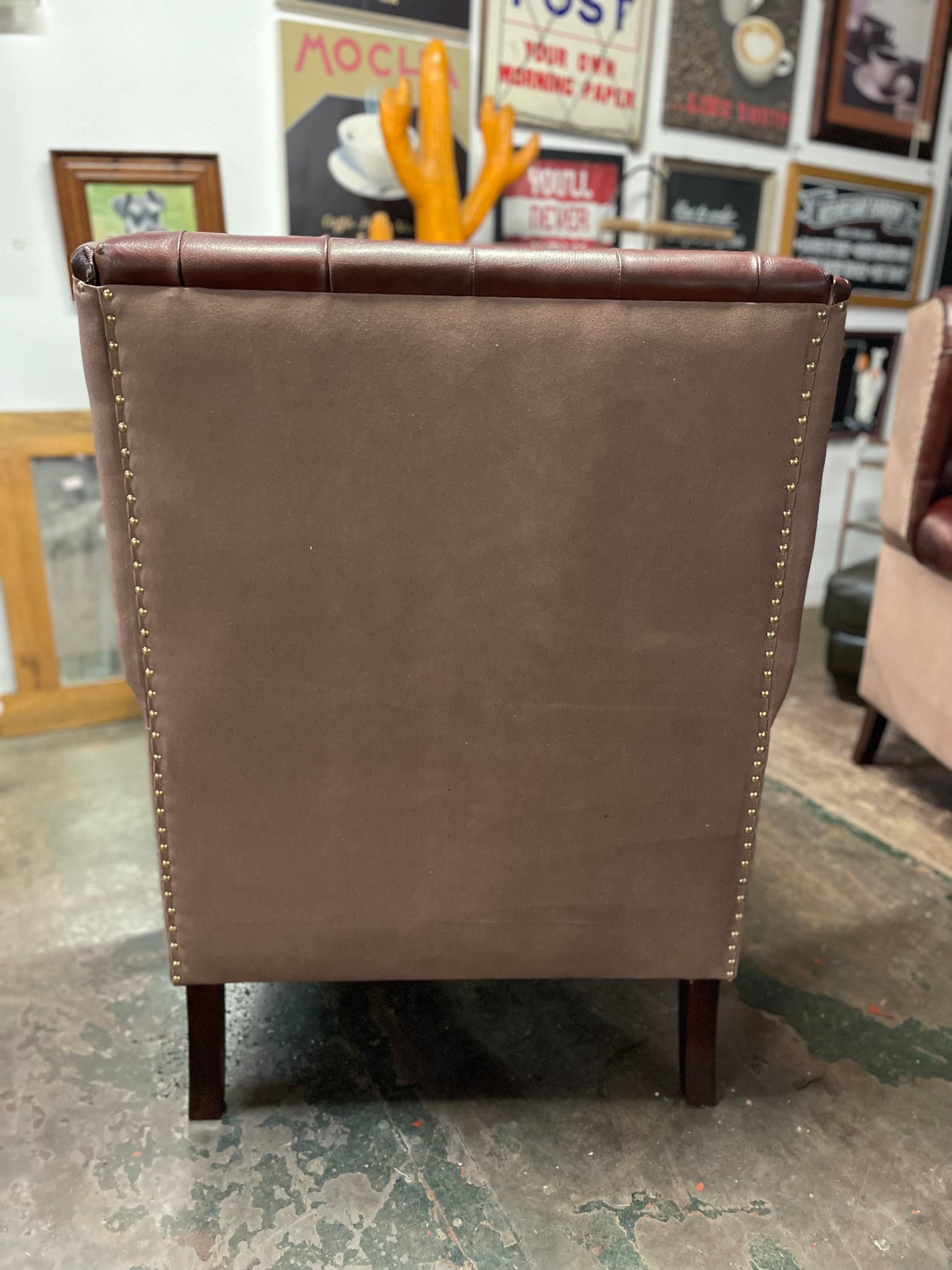 Chestnut brown leather armchair with button back