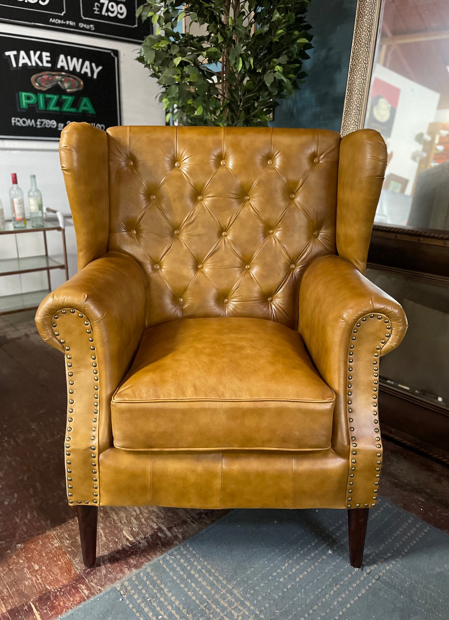 Tan leather armchair with button back