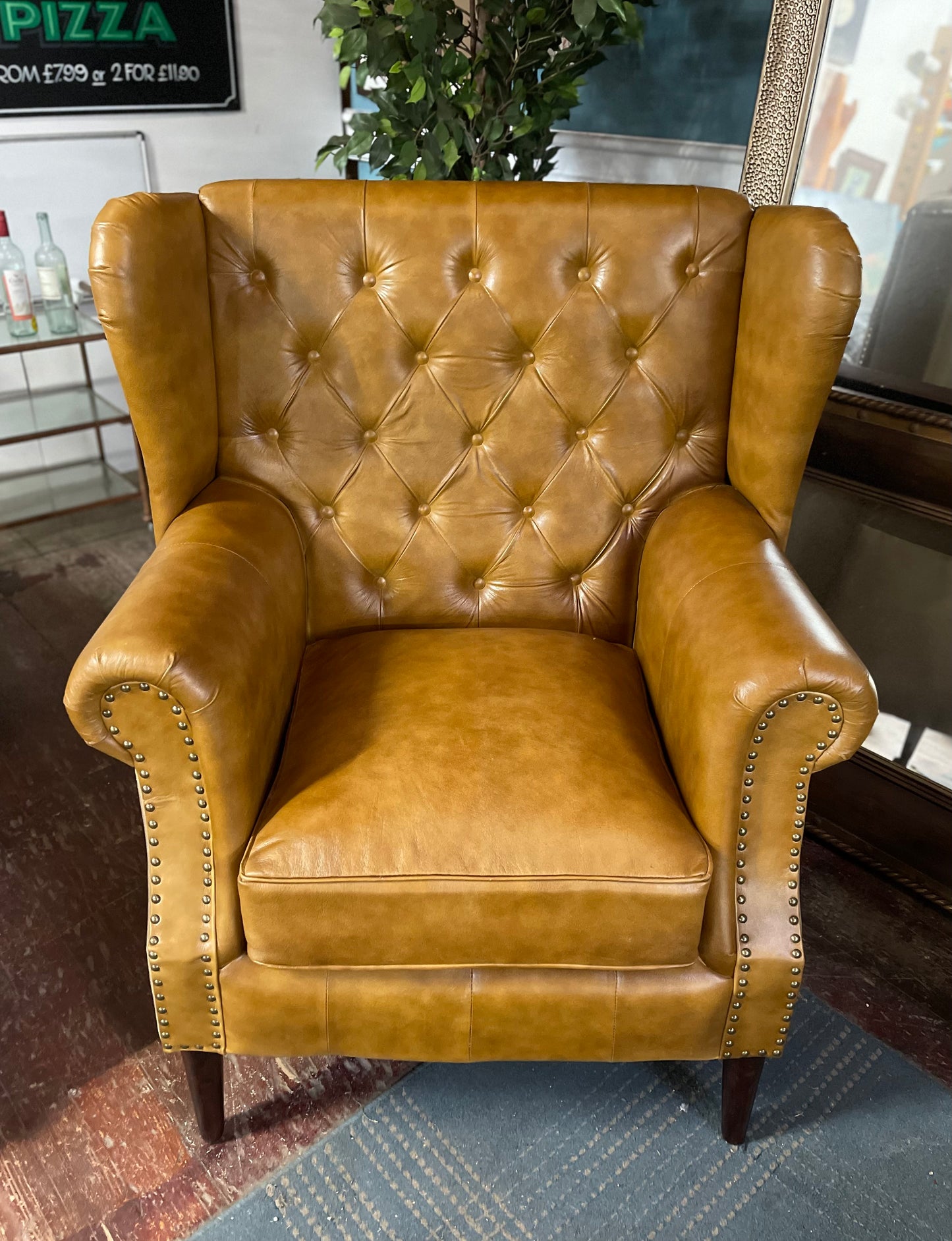 Tan leather armchair with button back