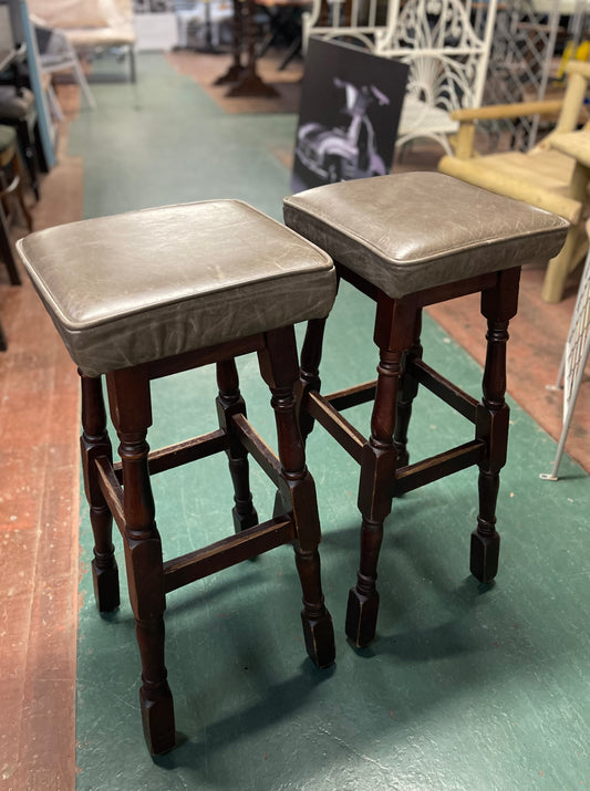 Pair of wooden bar stools with square grey leather tops