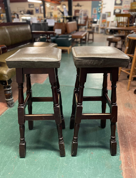 Pair of wooden bar stools with square grey leather tops