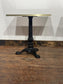 Pair of Marble Effect Bistro Tables with Ornate Black Cast Iron Bases Gold Trim