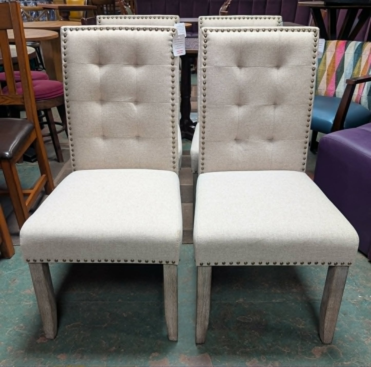 Set of Four Off-White Fabric Upholstered Dining Chairs / Brass Studs