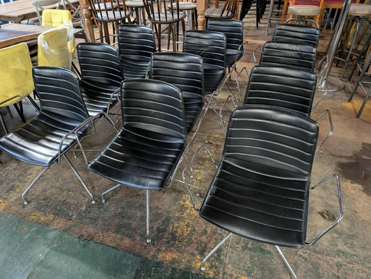 Set of 11 black faux leather swivel chairs with chrome frames