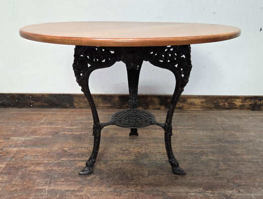 Medium Round Dining Table with Ornate Cast Iron Base and Light Wood Top