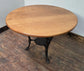 Medium Round Dining Table with Ornate Cast Iron Base and Light Wood Top